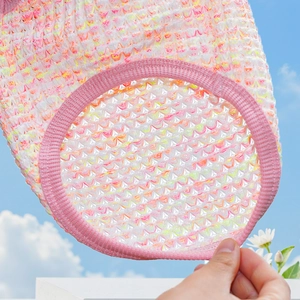 Close-up of breathable pink and yellow mesh pet shirt fabric with pink ribbed edging detail
