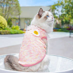 Close-up of pink and yellow tweed pet vest with lace collar and sunflower patch embroidery