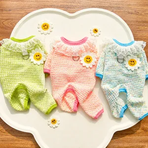 Close-up of breathable knit pet jumpsuit with lace collar and crochet daisy detail
