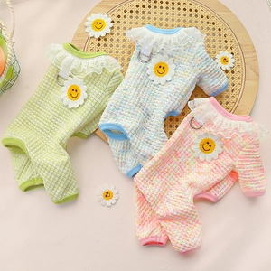 Detail of waffle texture pet onesie with lace collar and daisy decoration in pastel colors