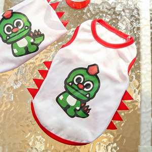 Detail of white mesh pet vest with green dinosaur print and red felt serrations