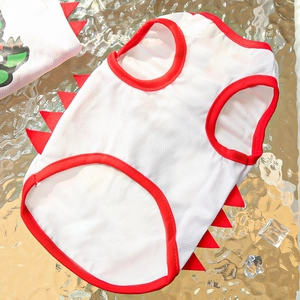 Detail of white mesh pet vest with red dinosaur fins and breathable cooling fabric texture
