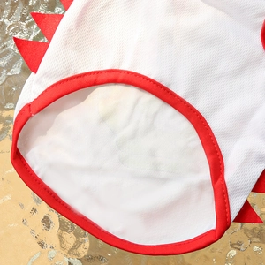 Detail of breathable white mesh pet vest with red trim and dinosaur fabric spikes