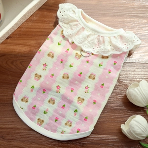 Detail of pink striped pet vest dress with lace collar and metal D-ring for leash