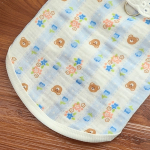 Detail of dog pajama fabric with bear patterns, lace trim, and metal D-ring attachment