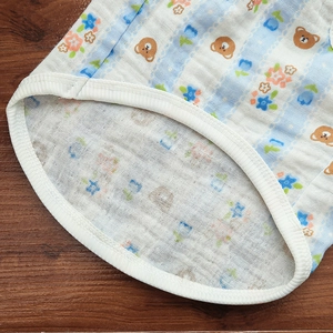 Close-up of cotton pet shirt showing breathable blue striped fabric with bear patterns