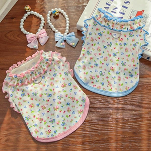 Floral knit pet vests with ruffles and pearl collars on a natural wooden background