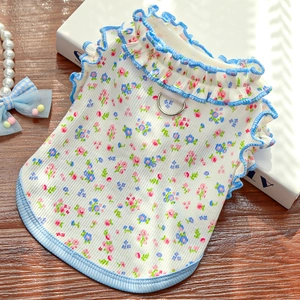 Detail of floral pet summer vest with frilled blue edges and metal D-ring attachment