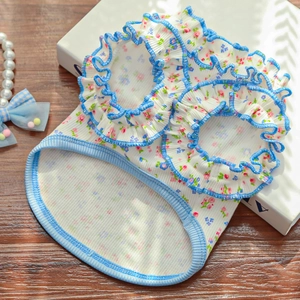 Detail view of pet floral camisole featuring blue ruffled edges and ribbed cotton fabric