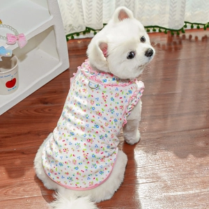 Detailed view of floral pet vest featuring pink ruffled edges and a metal D-ring buckle