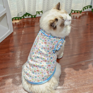 Detailed view of floral pet vest with blue ruffled edges and metal D-ring for leash