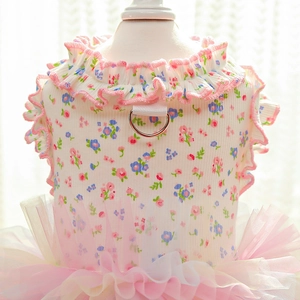Detail of floral pet dress with ruffled edges and metal D-ring for leash attachment