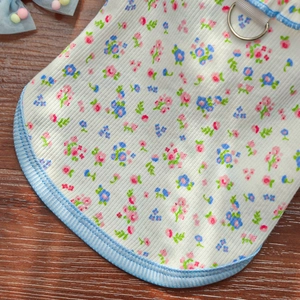 Detail of floral pet harness dress with metal D-ring and blue striped edging