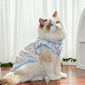 Close-up of floral pet vest featuring ruffled blue edges and breathable cotton texture