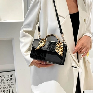 Fashionable black leopard patchwork square handbag with printed scarf on model