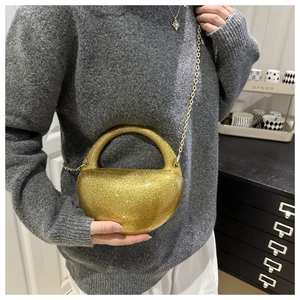 Detail of gold sequin half-moon acrylic box bag with a delicate metallic chain strap