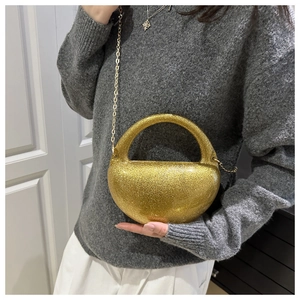Golden glitter semi-circular handbag shown with stylish chain strap and round handle