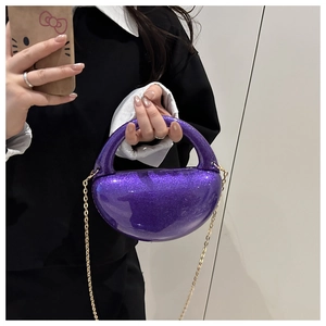 Close-up of sparkling purple glitter half-moon clutch bag with gold chain strap