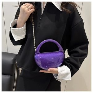 Detail view of purple glitter acrylic evening bag with gold chain and unique curved handle