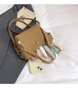 Macro detail of brown woven bucket bag interior showing spacious storage for cosmetics