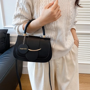 Minimalist black matte leather crossbody bag with gold smile metal bar and round handle