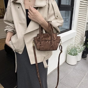 Brown textured leather handbag with Fashion & Bags lettering and adjustable shoulder strap