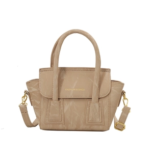 Elegant beige tote bag with textured faux leather and adjustable gold-buckle strap