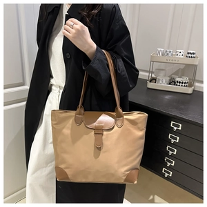 Lifestyle shot of large capacity tote bag with leather patchwork and buckle detail