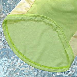 Detail of breathable ice silk dog vest featuring green mesh fabric and fine stitching
