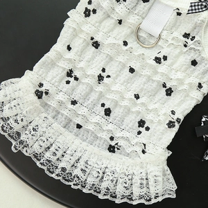 Detail of layered ruffle pet dress with floral lace and metal D-ring for leash attachment
