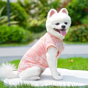 Close-up of light pink ice silk pet vest on Pomeranian dog in a garden setting