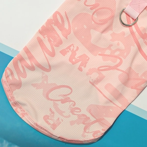 Detail of pink mesh pet cooling vest with graffiti print and metal D-ring for leash