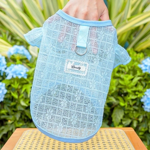 Detail of light blue lace pet vest featuring a metal D-ring and Beauty label decoration