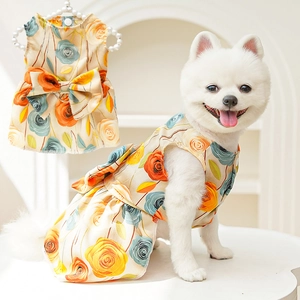 Close-up of pet summer dress with orange 3D roses and a large decorative bow on back