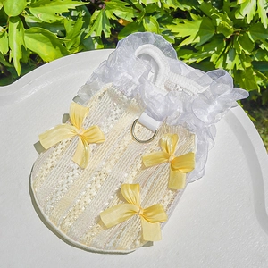 Detail of pet summer lace dress with organza ruffles, yellow bows and metal D-ring