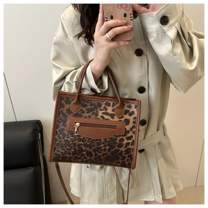 Close-up of leopard print handbag with functional zipper pocket and crossbody strap