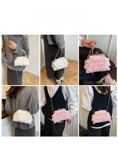 Detail shot of vintage lace ruffle handbags in pink and white with pearl chain and gold clasp