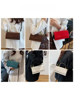 Detail showing various colors of quilted crossbody bags with circular metal handles and straps
