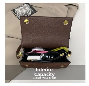 Internal capacity of brown leather crossbody bag with cosmetics and smartphone