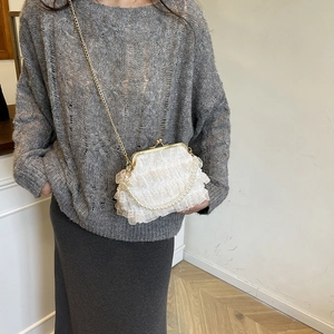 Elegant white lace ruffled crossbody bag with pearl handle and golden chain strap
