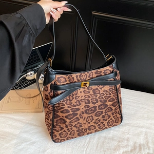Detail showing high-quality leopard print suede texture and gold buckle of bucket bag