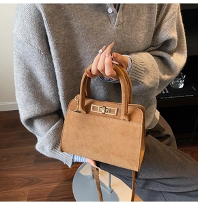 Brown frosted suede handbag featuring a gold rectangle twist lock and shoulder strap