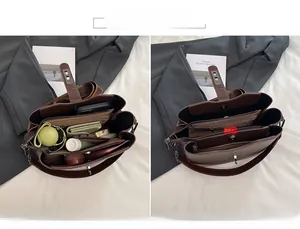 Detail view of large capacity dark brown leather bucket bag with multi-layer interior compartments