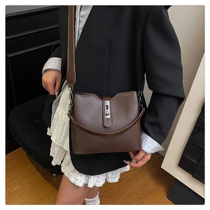 Brown vintage bucket bag with textured leather detail and stylish metal buckle closure