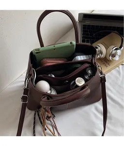 Interior view showing the large capacity and multiple compartments of the brown tote bag