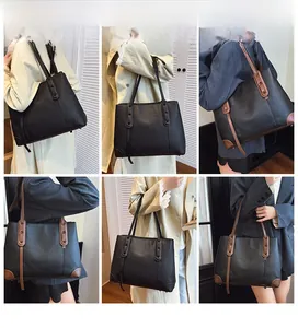 Dettagli della borsa tote grande in pelle martellata nera mostrata su una modella