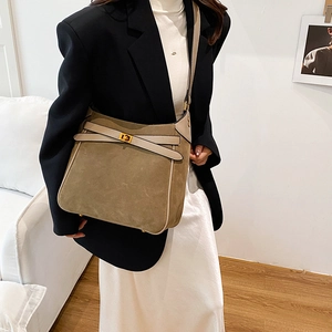 Olive green suede bucket bag with gold hardware and stylish crossbody shoulder strap
