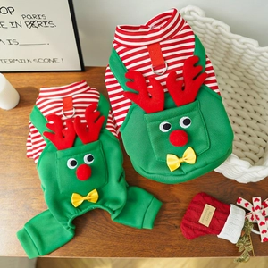 Close-up of Christmas pet outfits with 3D reindeer decor and metallic D-rings on wood