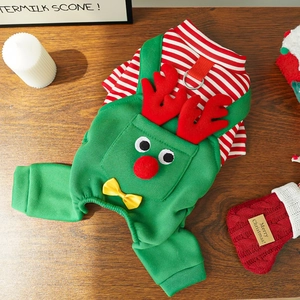 Christmas dog onesie with elk design and red white stripes on a festive wooden desk