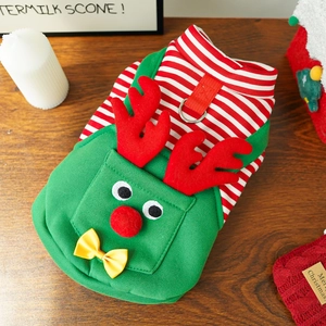 Detail of Christmas dog sweater with reindeer horns, bow, and D-ring on wood background